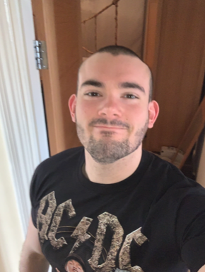 bald Man in black ACDC tshirt looking to camera